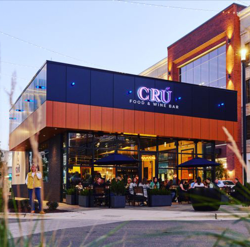 Photo of CRU Fenton location with guests sitting outside under umbrellas.